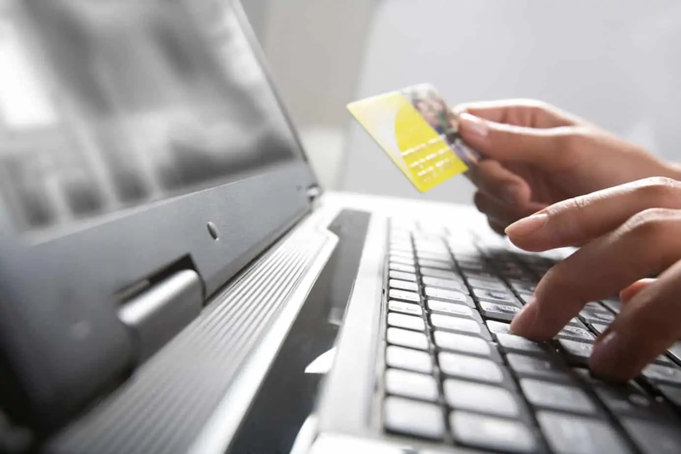 image of person processing credit card with ecommerce software for distributors